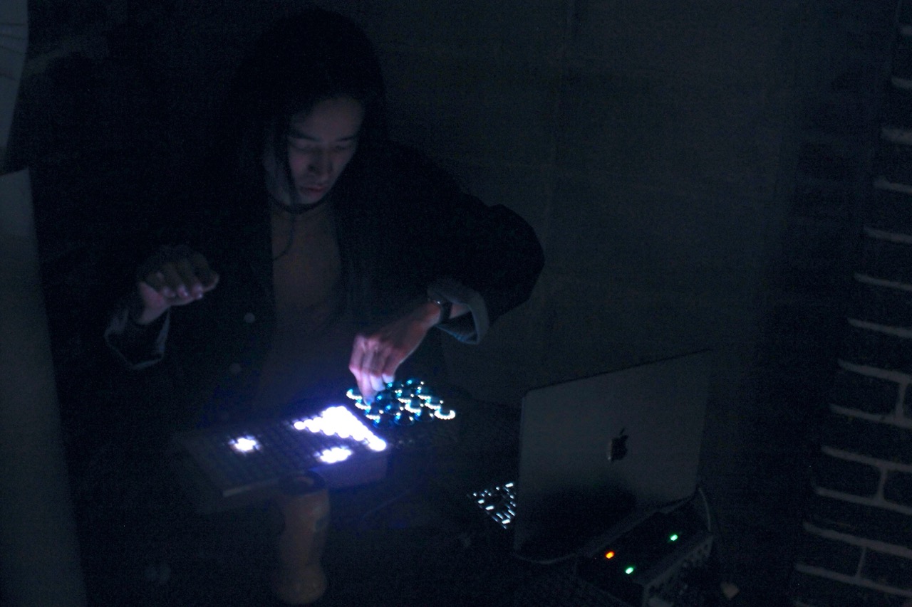 Alexander playing controllers in front of a laptop